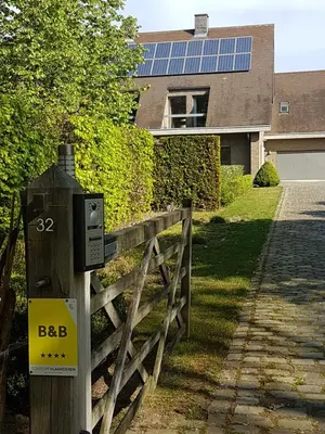 a solar meter on a fence in front of a house at B & B DE SERAFIJN in Lochristi