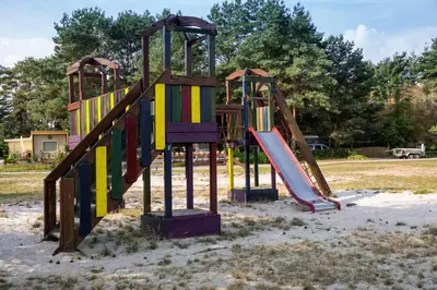 a playground with a slide in a park at Safaritent at Camping GT Keiheuvel in Balen