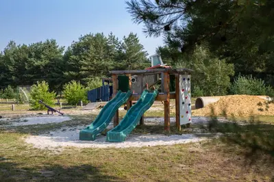 a playground with a slide in a park at Safaritent at Camping GT Keiheuvel in Balen