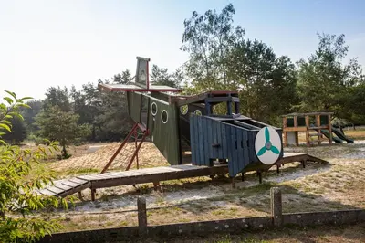 a playground in a park with a slide at Safaritent at Camping GT Keiheuvel in Balen