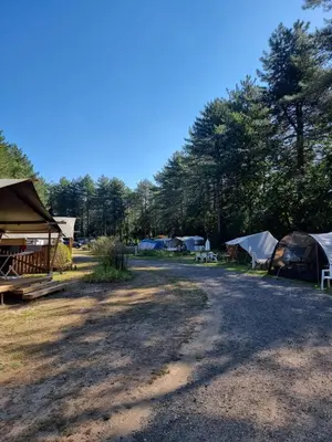 a group of tents and tables in a field at Camping Siësta in Lille