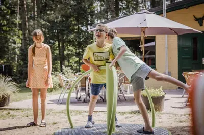 a couple of people playing in a playground at Camping Siësta in Lille