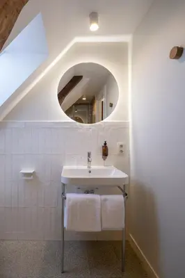 a bathroom with a sink and a mirror at Made in Catherine in Brussels
