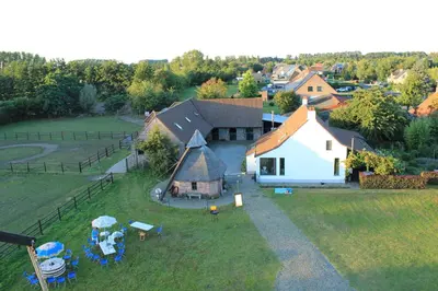 an aerial view of a farm with a building at De Rosmolen in Ertvelde