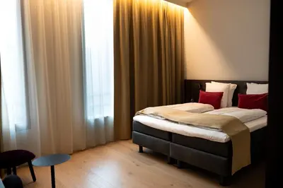 a bedroom with two beds and a window at Corsendonk Turnova in Turnhout