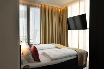 a bedroom with a bed with a large window at Corsendonk Turnova in Turnhout