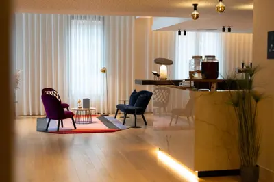 a living room with chairs and a table at Corsendonk Turnova in Turnhout