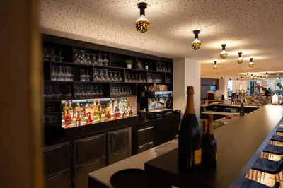 a bar with a lot of bottles of alcohol at Corsendonk Turnova in Turnhout