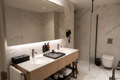 a bathroom with a sink and a mirror and a toilet at Corsendonk Turnova in Turnhout