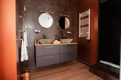 a bathroom with two sinks and two mirrors at Les Lofts d'Artistes in Brussels