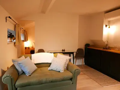 a living room with a couch and a table at De Gulle Beemden in Hulshout