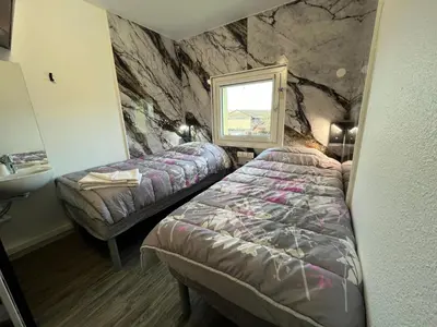 a hotel room with two beds and a sink at ClassEco Gent in Ghent