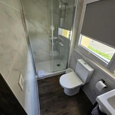 a bathroom with a toilet and a shower and a sink at ClassEco Gent in Ghent