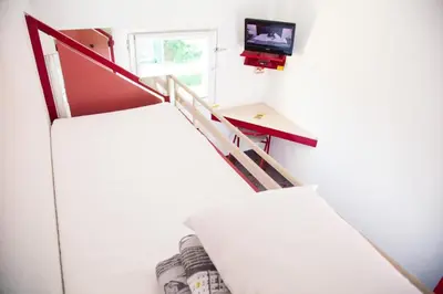 a staircase in a house with a tv on the wall at ClassEco Gent in Ghent