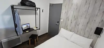 a hotel room with a bed and a mirror at ClassEco Gent in Ghent