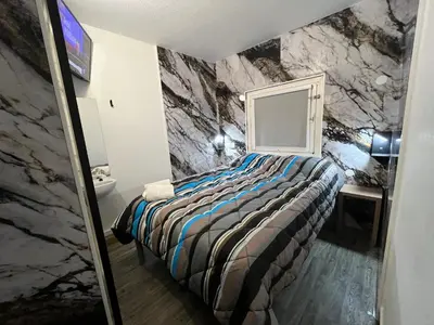 a bedroom with a bed and a rock wall at ClassEco Gent in Ghent