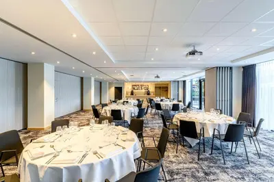 a banquet room with tables and chairs with white tablecloths at Radisson Hotel Antwerp Berchem in Antwerp