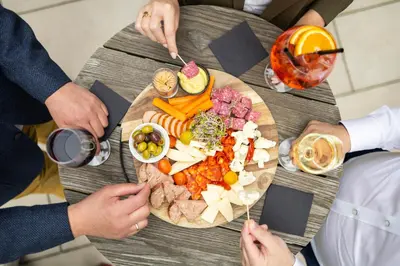 a group of people sitting around a table with food at Radisson Hotel Antwerp Berchem in Antwerp