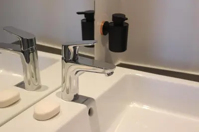 a bathroom sink with two faucets on it at CITYSTAY in Antwerp