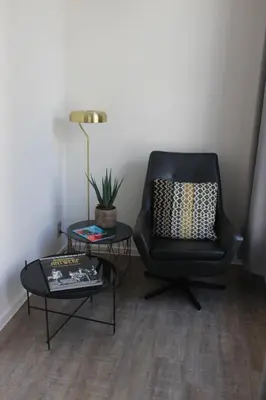 a living room with a chair and a table at CITYSTAY in Antwerp