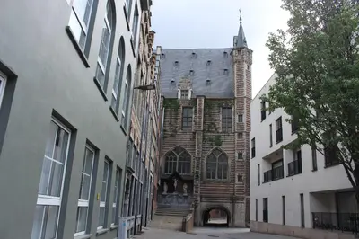 an old building with a clock tower on a street at CITYSTAY in Antwerp
