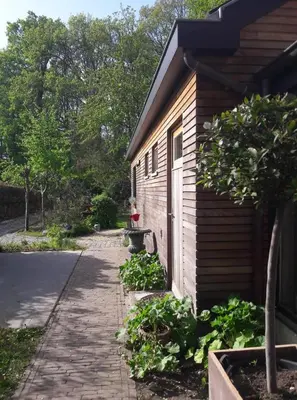 a building with a door and a sidewalk next to it at Beeltjens B&B: Wolf&Belle in Westerlo