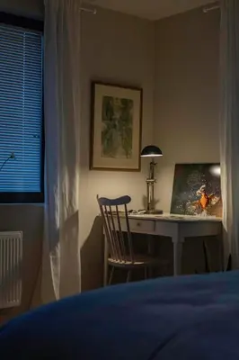 a bedroom with a desk with a laptop and a chair at Beeltjens B&B: Wolf&Belle in Westerlo