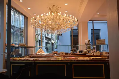 a chandelier and a display case in a store at Merveilleux in Ghent