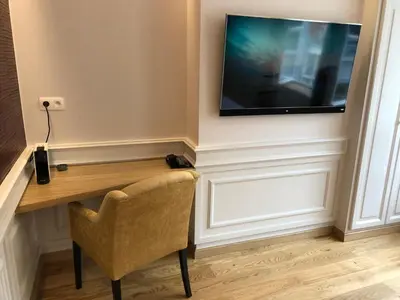 a desk in a room with a television on a wall at Merveilleux in Ghent
