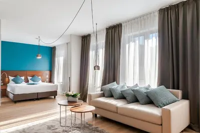 a living room with a couch and a bed at Aparthotel Residence Agenda in Brussels