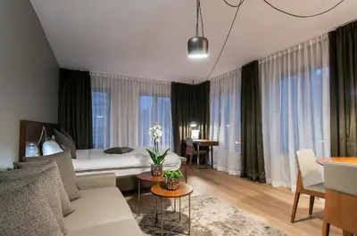 a bedroom with a bed and a living room at Aparthotel Residence Agenda in Brussels