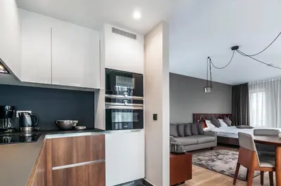 a kitchen and living room with a bed in the background at Aparthotel Residence Agenda in Brussels