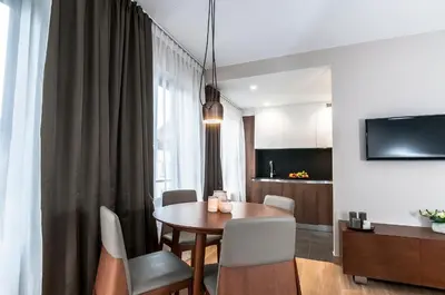 a dining room with a table and a kitchen at Aparthotel Residence Agenda in Brussels