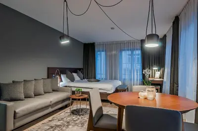a hotel room with a couch and a bed at Aparthotel Residence Agenda in Brussels