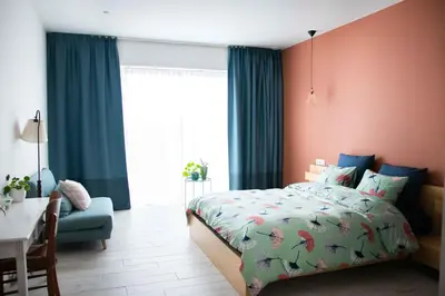 a bedroom with a bed and a desk and a window at Barbos in Lembeke