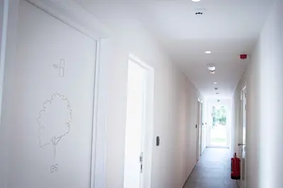 a hallway of a house with white walls and white floors at Barbos in Lembeke