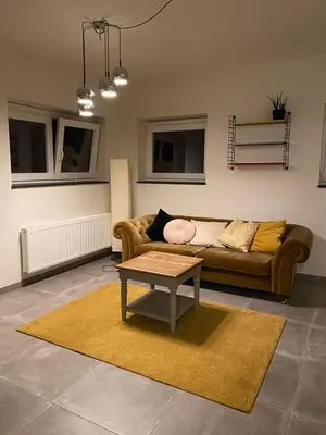 a living room with a couch and a table at Barbos in Lembeke