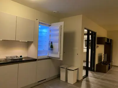 a kitchen with white cabinets and a window at Barbos in Lembeke