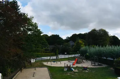 a park with a playground with play equipment in it at Barbos in Lembeke