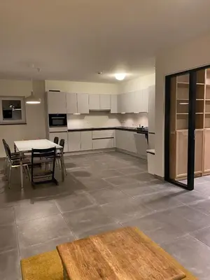 a kitchen with a table and a table and chairs at Barbos in Lembeke