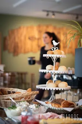 a woman standing in front of a table with a cake at Barbos in Lembeke