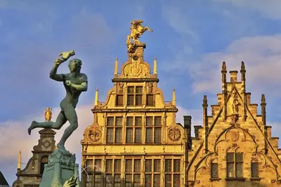 a large building with a statue in front of it at Noir Loft with Skyline View in Antwerp