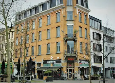 a large brick building on a city street at Noir Loft with Skyline View in Antwerp