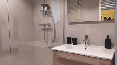 a bathroom with a sink and a shower at B&B Plattestien in Halle