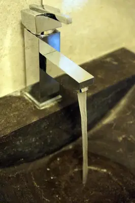 a water fountain sitting on top of a table at Studio Rempart in Brussels