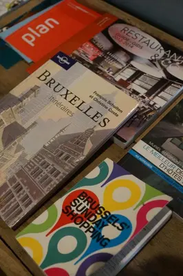 a table topped with brochures and magazines on a table at Studio Rempart in Brussels