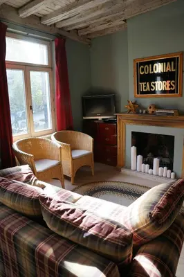 a living room with a couch and a fireplace at Studio Rempart in Brussels