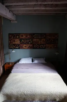 a bedroom with a white bed with a blue wall at Studio Rempart in Brussels