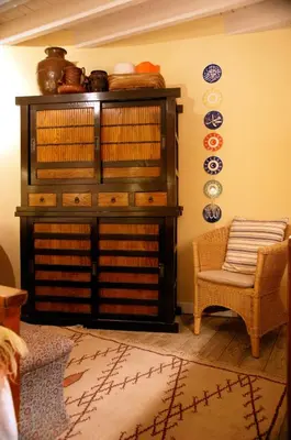 a room with a book shelf and a chair at Studio Rempart in Brussels
