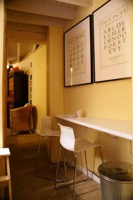 a table and chairs in a room with yellow walls at Studio Rempart in Brussels